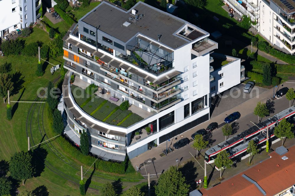 Freiburg im Breisgau from the bird's eye view: Building of an apartment building with green terraces in the tram - turning loop on the street Rieselfeldallee in the district Rieselfeld in Freiburg im Breisgau in the state Baden-Wuerttemberg, Germany