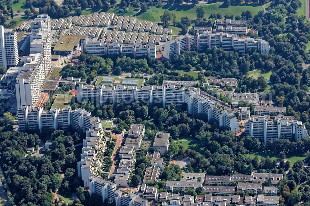 München from above - Building of the Olympiadorf residential complex in Munich, Bavaria. The one-storey bungalows and several high-rise buildings and terraces of the former Olympic village are used as the student dormitory