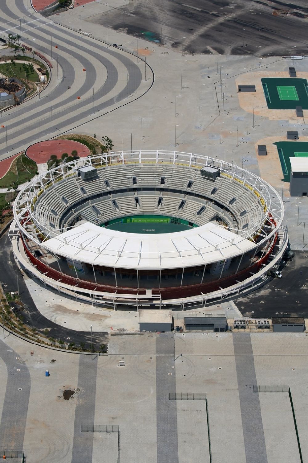 Rio de Janeiro from above - Building the tennis arena with green field in Barra Olympic Park before the summer playing games of XXII. Olympics in Rio de Janeiro in Rio de Janeiro, Brazil