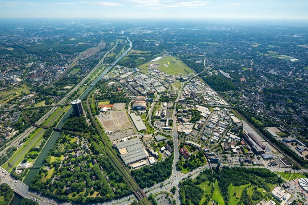 Oberhausen from above - Building complex and grounds of the logistics center Deufol SE on Essener Strasse near Gasometer Oberhausen GmbH. Behind this Neue Mitte Oberhausen with shopping center CentrO Management GmbH and Leisure center with LEGOLANDA? Discovery Centre Oberhausen, AQUApark Oberhausen GmbH, SEA LIFE Oberhausen, Koenig-Pilsener-Arena und BusinessPark.O along the river Rhein-Herne-Kanal on the former steelworks site of Gutehoffnungshuette in Oberhausen in the state North Rhine-Westphalia, Germany