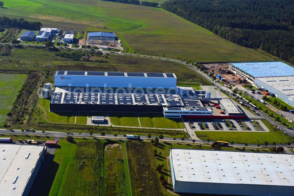 Gallin from the bird's eye view: Building complex and grounds of the logistics center of Schur Pack Germany GmbH on Neu-Galliner Ring overlooking a construction site for the extension of the local logistic center in Gallin in the state Mecklenburg - Western Pomerania, Germany