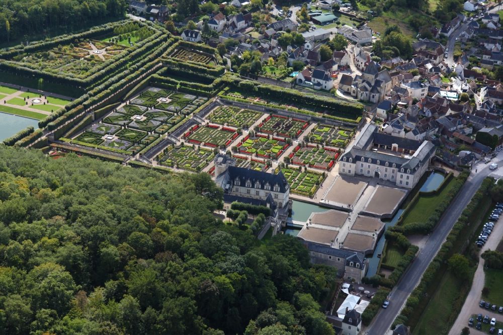 Villandry from above - Building complex in the park of the castle Chateau Villandry in Villandry in Centre-Val de Loire, France. The present castle was built by Jean Le Breton, finance minister under King Franz I, in the Renaissance style. The gardens, reconstructed according to old engravings, plans and gardens, are located on three levels: the sun garden, ornamental gardens with beech tree decorations, and a multi-colored kitchen garden consisting of nine squares