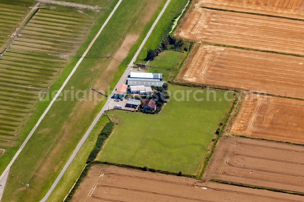 Aerial image Nordstrand - Homestead and farm outbuildings on the edge of agricultural fields with Hofladen on street Pohnshalligkoogstrasse in Nordstrand North Friesland in the state Schleswig-Holstein, Germany