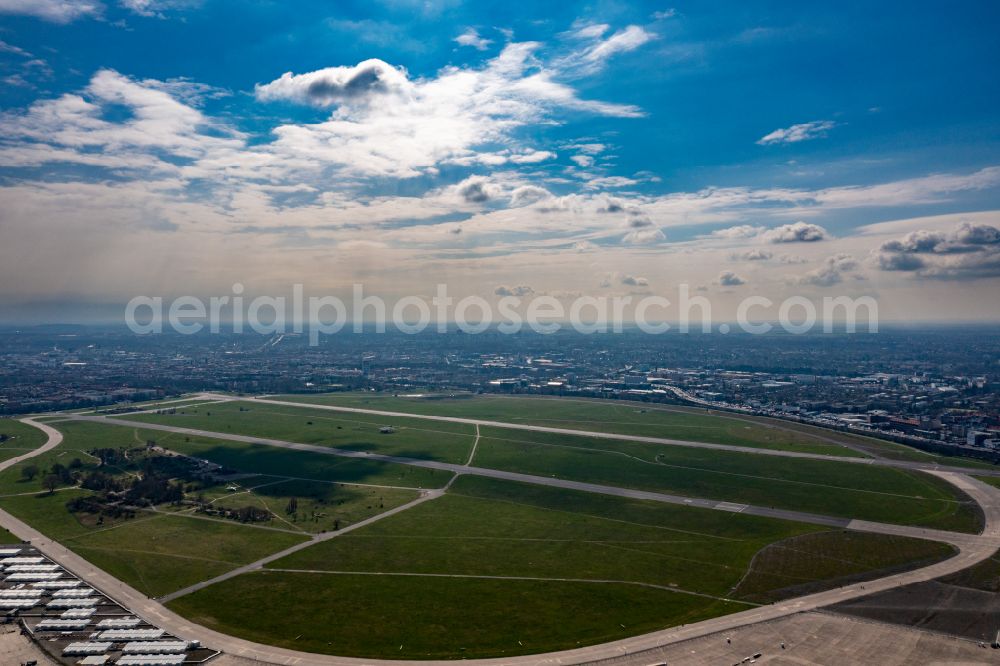 Aerial image Berlin - Premises of the former airport Berlin-Tempelhof Tempelhofer Freiheit in the Tempelhof part of Berlin, Germany. The premises include the historic main building and radar tower as well as two runways. Its hangars are partly used as refugee and asylum seekers accommodations