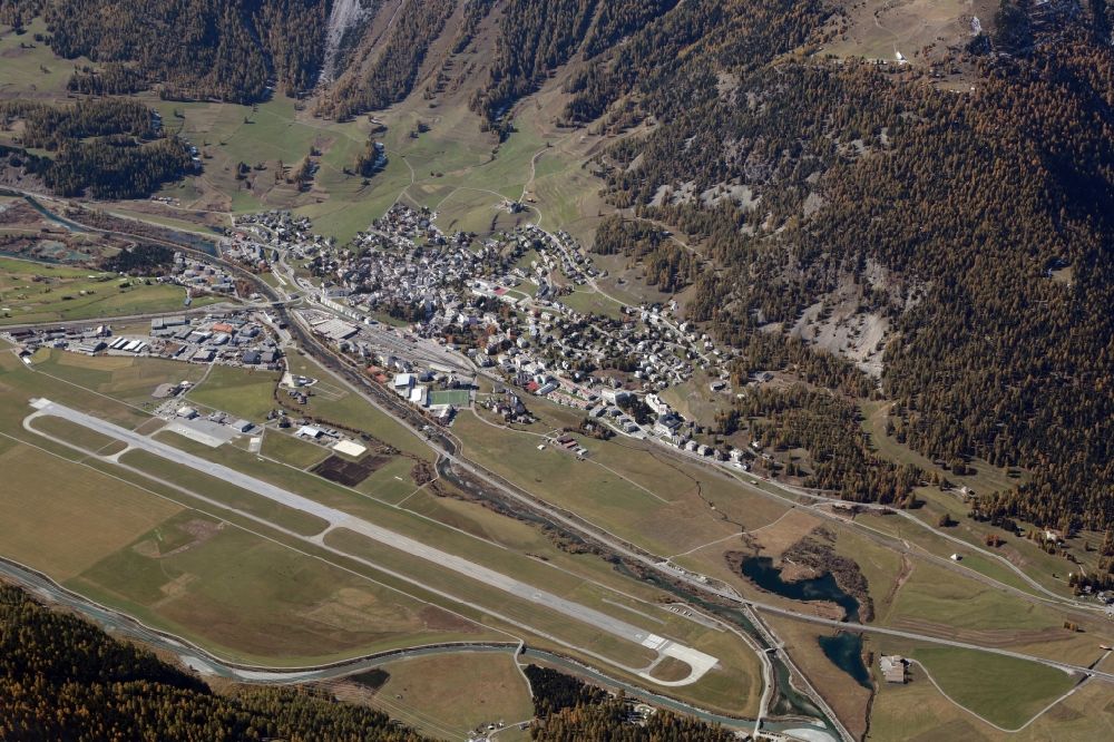 Samaden from above - Runway with hangar taxiways and terminals on the grounds of the airport Engadin Airport Plazza Aviatica in Samaden in the canton Graubuenden, Switzerland