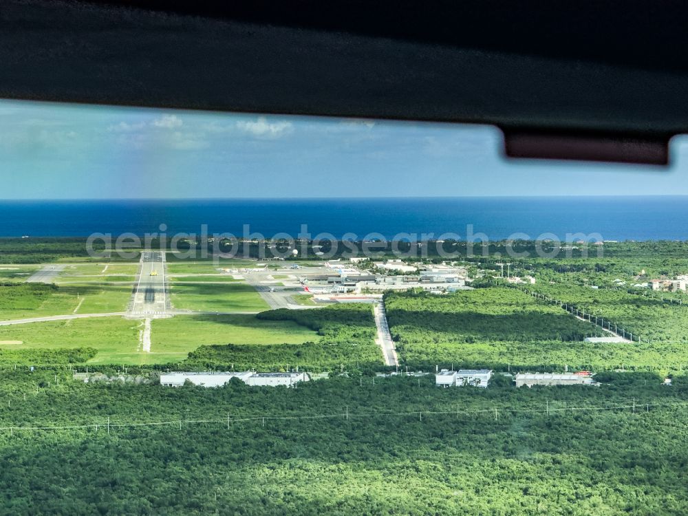 Punta Cana from above - Runway with hangar taxiways and terminals on the grounds of the airport Punta Cana, PUJ on street Airport Services Road in Punta Cana in La Altagracia, Dominican Republic