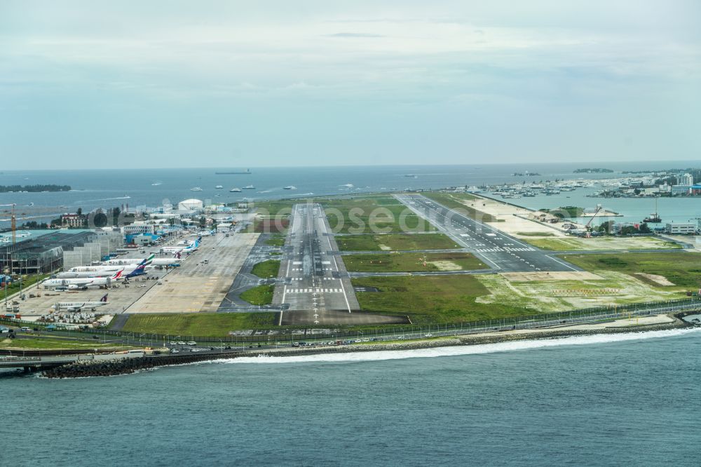 Male from above - Runway with hangar taxiways and terminals on the grounds of the airport Velana International Airport in Male in Maldives