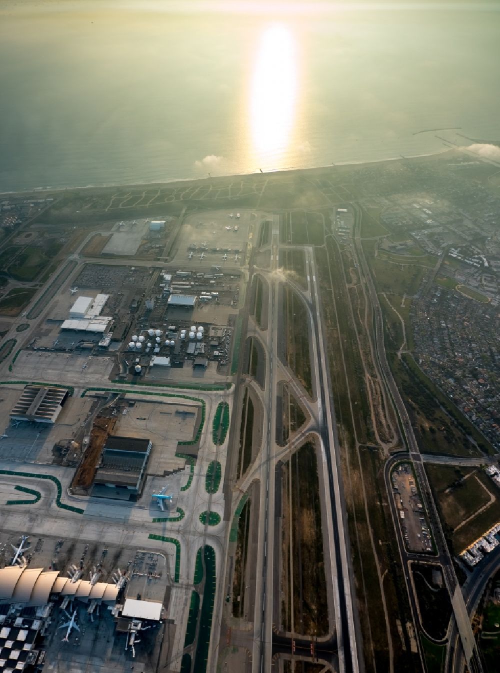 Los Angeles from above - Runway with hangar taxiways and terminals on the grounds of Los Angeles International Airport LAX in sunset in Los Angeles in California, USA