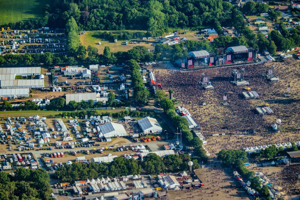 Wacken from the bird's eye view: Participants in the Wacken music festival on the event concert area on street Norderstrasse in Wacken in the state Schleswig-Holstein, Germany