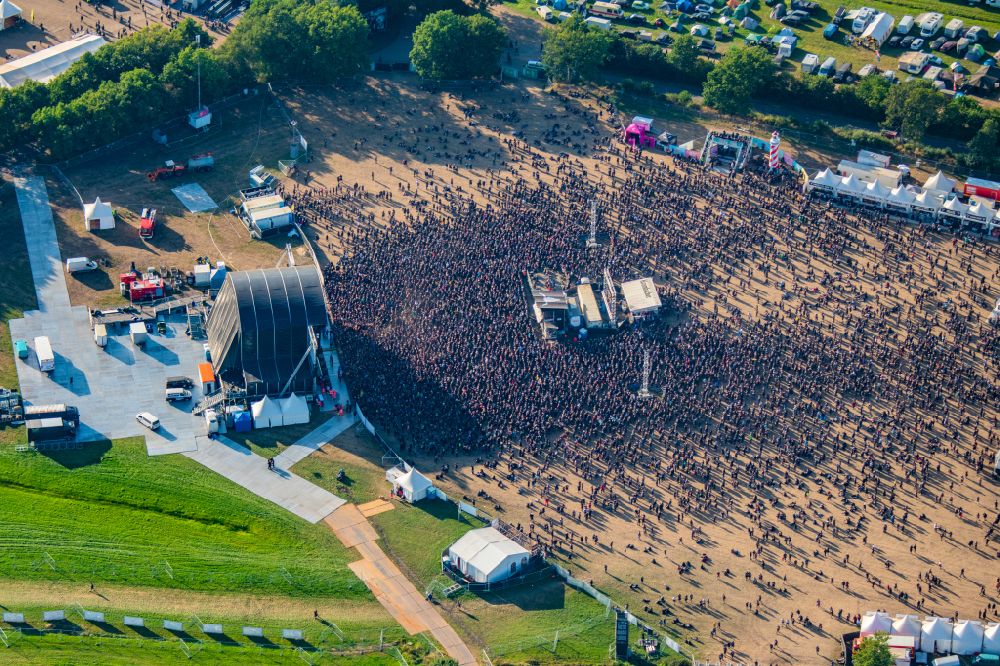 Aerial image Wacken - Participants in the Wacken music festival on the event concert area on street Norderstrasse in Wacken in the state Schleswig-Holstein, Germany