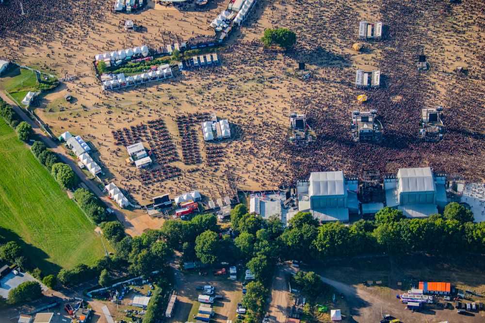 Aerial photograph Wacken - Participants in the Wacken music festival on the event concert area on street Norderstrasse in Wacken in the state Schleswig-Holstein, Germany