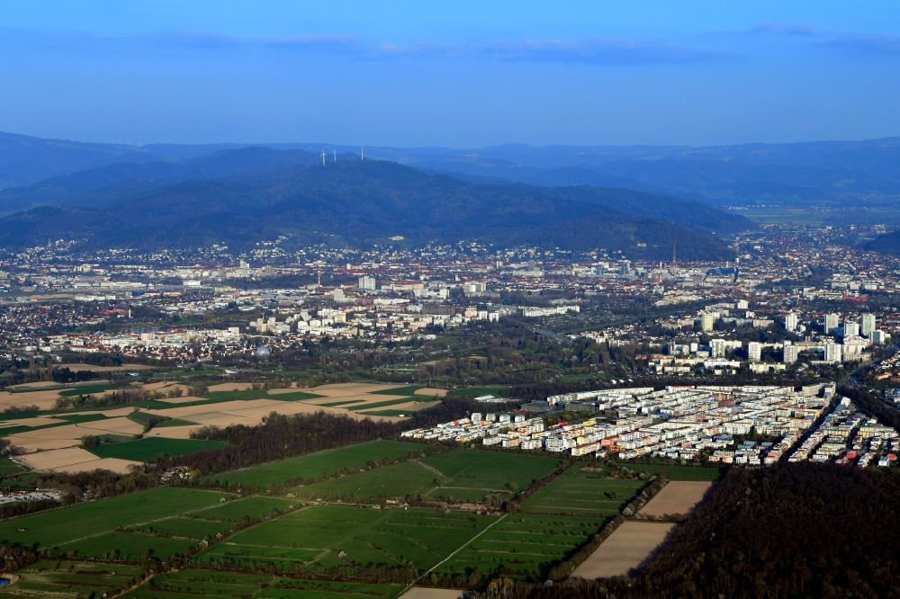 Aerial photograph Freiburg im Breisgau - City area with outside districts Rieselfeld und Dietenbach in Freiburg im Breisgau in the state Baden-Wurttemberg, Germany. Looking to the mountains of the Black Forest