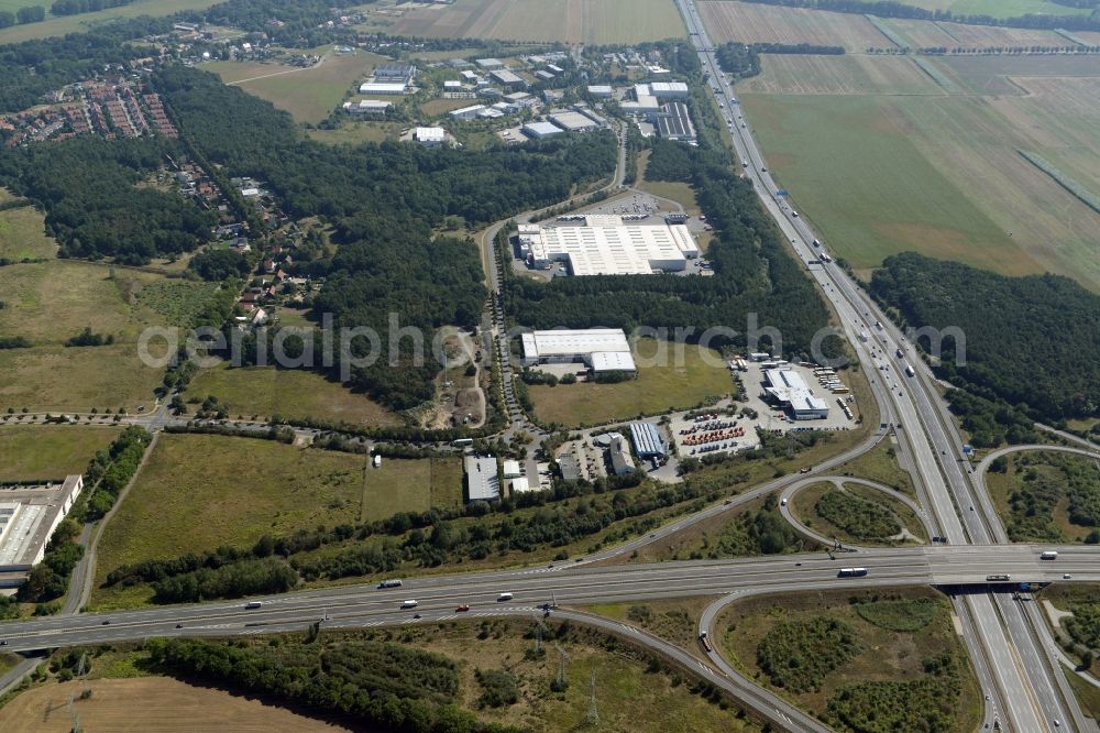 Aerial image Ludwigsfelde - Intersection Ludwigsfelde-Ost in Ludwigsfelde in the state of Brandenburg. The interchange connects the federal road B101 and the federal motorway A10. A commercial area with a hotel and a branch of Coca-Cola is located in its Northeast on Parkallee