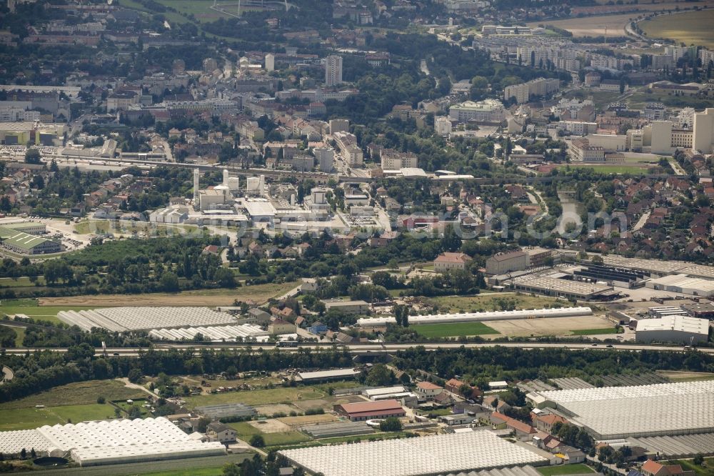 Aerial image Schwechat - Industrial estate and company settlement along federal motorway A4 in Schwechat in Lower Austria, Austria. The area is located at the edge of the city of Vienna with the Kaiserebersdorf part of Vienna in the background