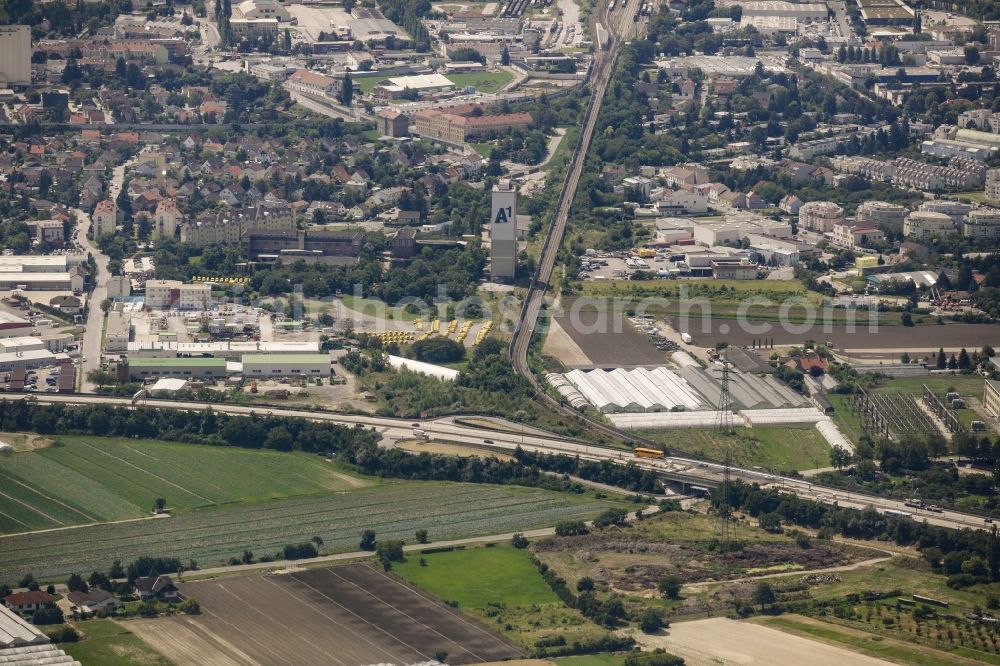 Aerial photograph Schwechat - Industrial estate and company settlement along federal motorway A4 in Schwechat in Lower Austria, Austria. The area is located at the edge of the city of Vienna with the Kaiserebersdorf part of Vienna in the background