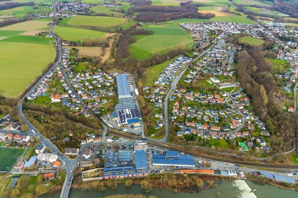 Aerial photograph Fröndenberg/Ruhr - Industrial estate and company settlement along the Ruhr with a dam and a bridge structure at Unnaer Strasse / Ardeyer Strasse in the district Langschede in Froendenberg/Ruhr in the state North Rhine-Westphalia, Germany
