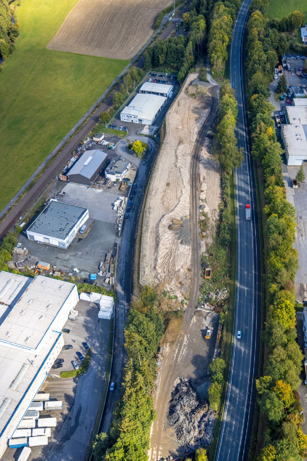 Aerial photograph Bestwig - Industrial estate and company settlement with a sandy area along the L743 on street Im Oehler in the district Velmede in Bestwig at Sauerland in the state North Rhine-Westphalia, Germany