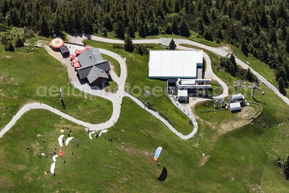 Kössen from the bird's eye view: Paraglider taking off at the Unterberghorn launch site in Koessen in Tyrol, Austria