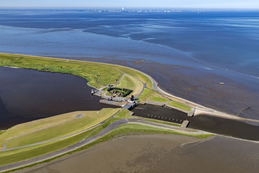 Aerial photograph Krummhörn - Since 1991, the barrier plant Leysiel with Siel and lock forms the final construction of the dyke nose Leyhoern, the core of the coastal protection measure Leybucht. The 30 meter wide Siel supports the drainage function of the plants in Greetsiel and Leybuchtsiel. The inland lake of 200 hectares of storage lake serves both to absorb the water draining through the river Siele and as storage space when inland water is pumped in via pumping stations in case of several-day storm tides