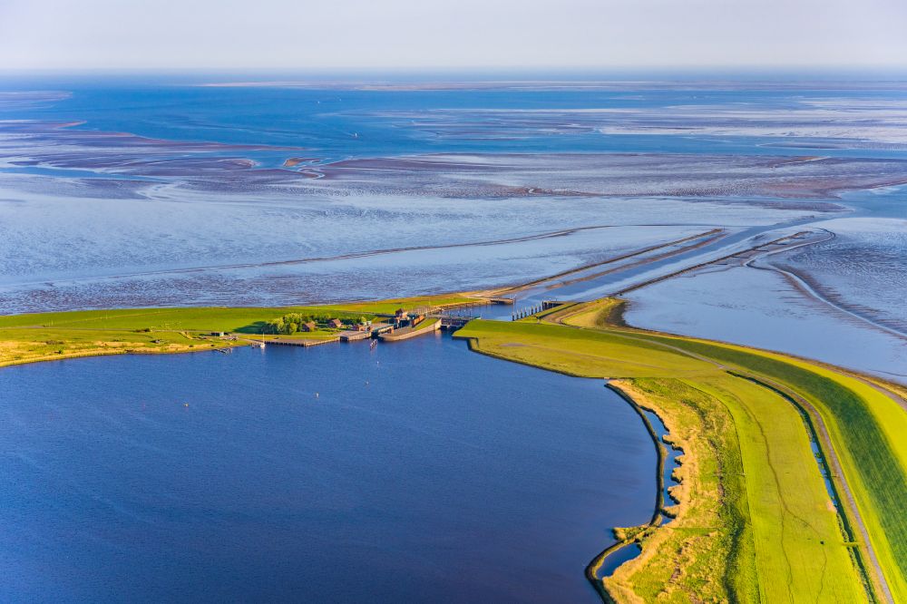 Aerial image Krummhörn - Since 1991, the barrier plant Leysiel with Siel and lock forms the final construction of the dyke nose Leyhoern, the core of the coastal protection measure Leybucht. The 30 meter wide Siel supports the drainage function of the plants in Greetsiel and Leybuchtsiel. The inland lake of 200 hectares of storage lake serves both to absorb the water draining through the river Siele and as storage space when inland water is pumped in via pumping stations in case of several-day storm tides