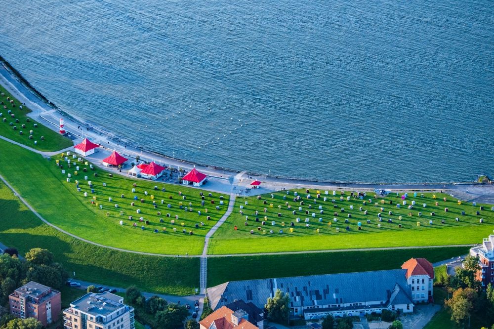 Cuxhaven from above - The Grimmershoernbucht with the dike system Doeser Sea dike with beach chairs in the evening sun in Cuxhaven Doese in the state of Lower Saxony