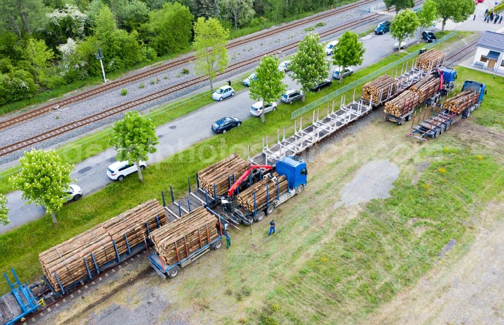 Pockau-Lengefeld from the bird's eye view: Loading of wagons with tree trunks of a train in freight traffic on the track in Pockau-Lengefeld in the state Saxony, Germany