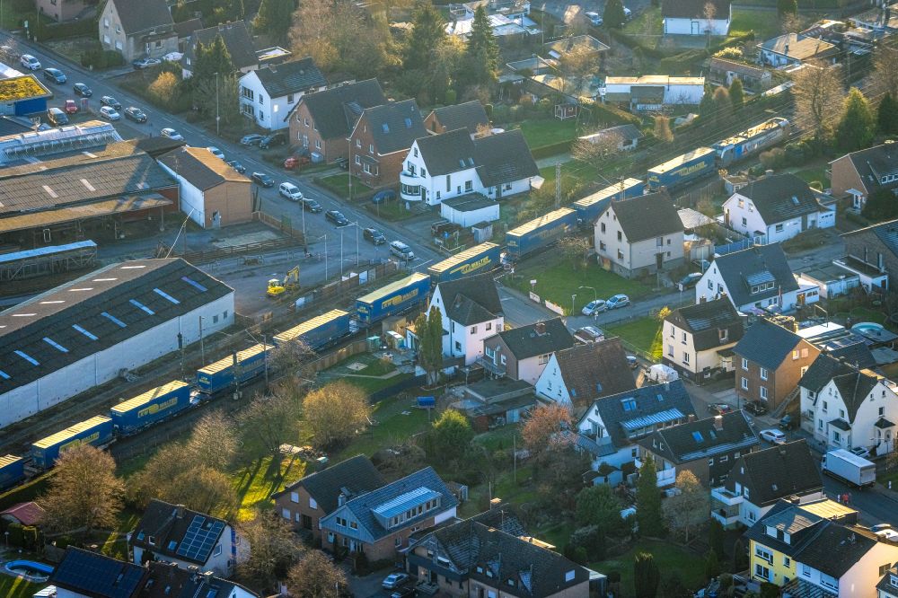 Hamm from the bird's eye view: Driving a train with wagons from LKW Walter in freight traffic on the track at the level crossing Langewanneweg in Hamm in the Ruhr area in the state of North Rhine-Westphalia, Germany