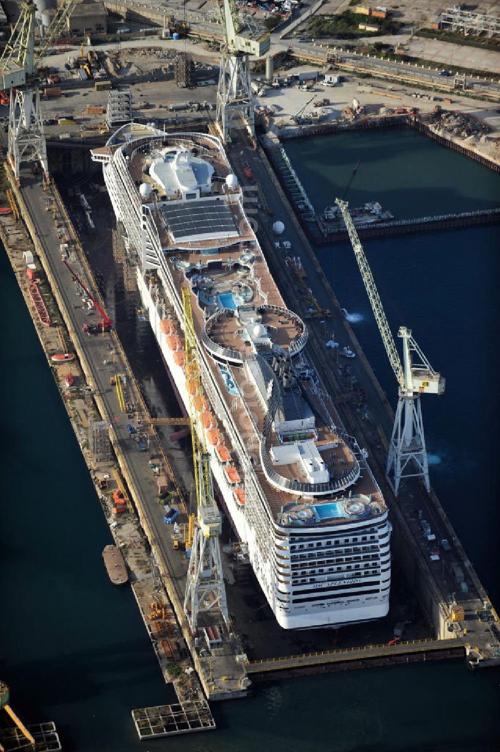 Palermo Sizilien from above - Fincantierii yard with the cruise ship MSC Splendida, of the Italian shipping company MSC Crociers S.A. for the overhaul at the dry dock of the shipyard in Palermo, Sicily, Italy