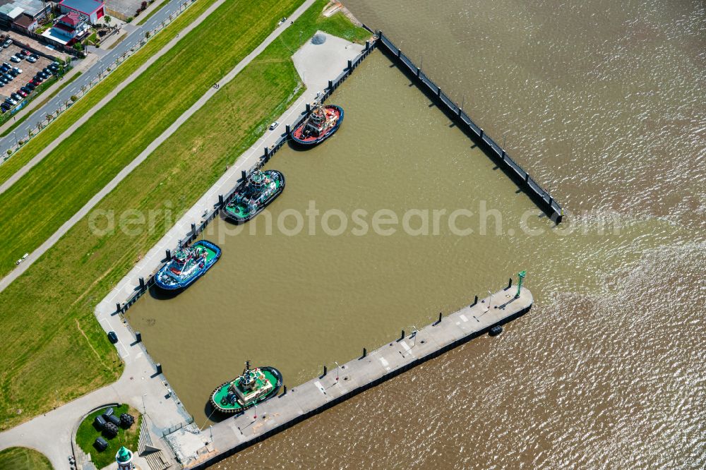 Aerial image Bremerhaven - Port facilities with tugboat on the shores of the harbor Bremerhaven in the state Bremen, Germany