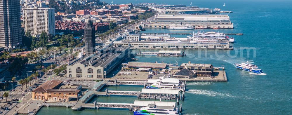 Aerial image San Francisco - Port facilities and white clock tower on the shores of the harbor of des Ferry Terminal in San Francisco in USA