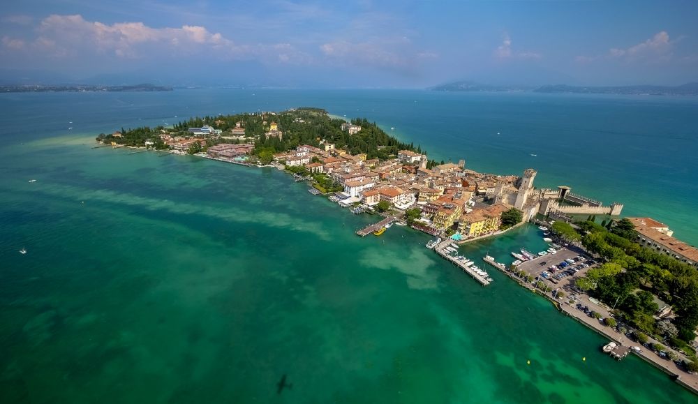 Aerial photograph Sirmione - Headland Sirmione at the Garda See in Lombardia, Italy. In the picture the castle Castello scaligero and the harbour