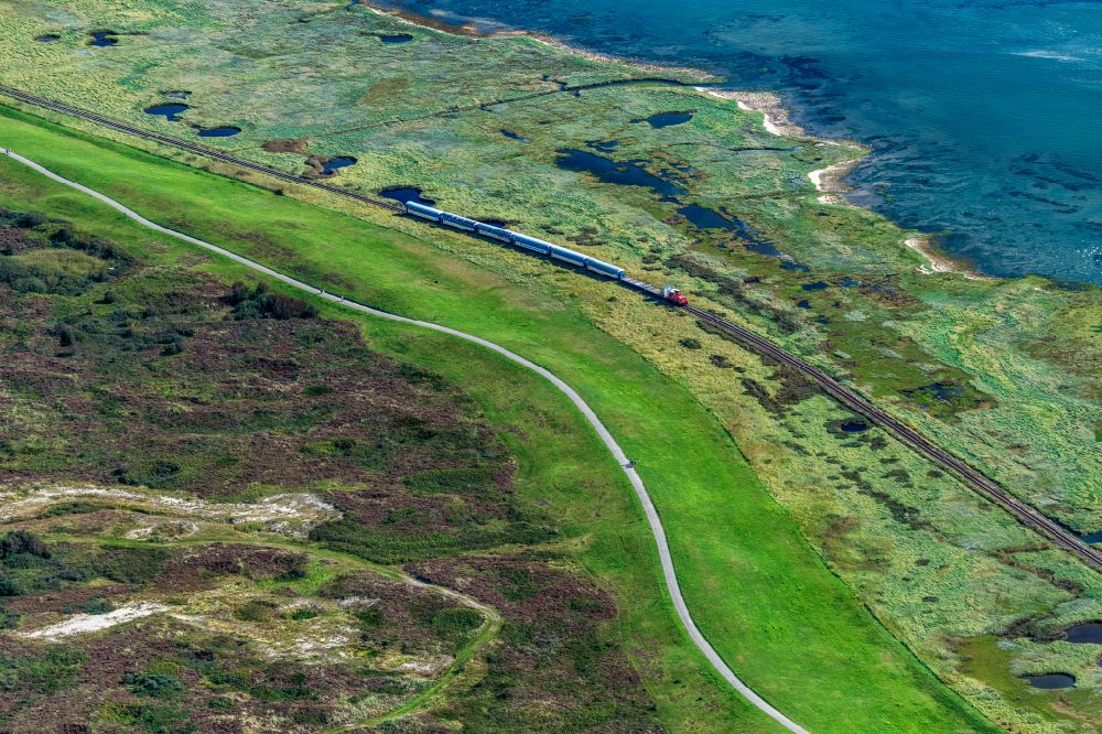 Wangerooge from above - Grassland structures of a Hallig landscape with moving train of the Wangerooger Inselbahn - narrow-gauge railway in Wangerooge in the state Lower Saxony, Germany