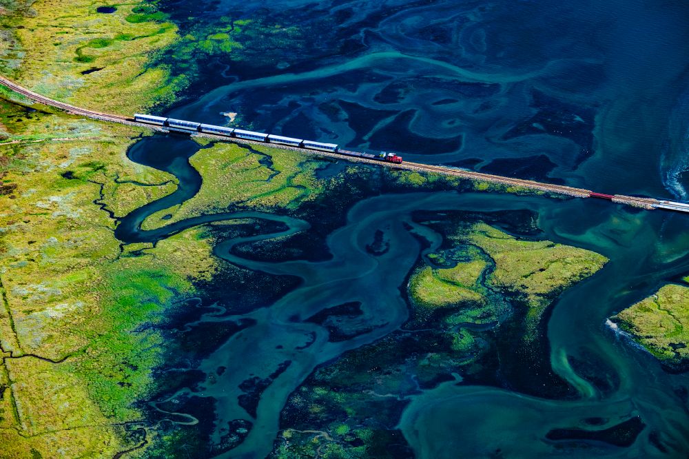 Aerial photograph Wangerooge - Grassland structures of a Hallig landscape with moving train of the Wangerooger Inselbahn - narrow-gauge railway in Wangerooge in the state Lower Saxony, Germany
