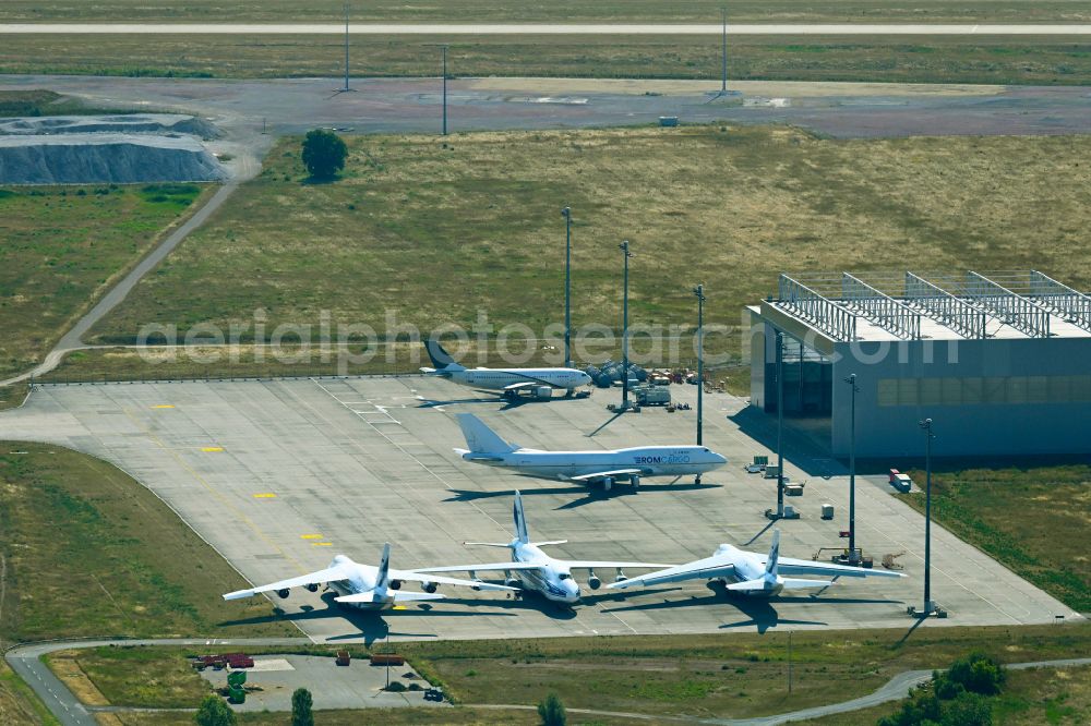 Schkeuditz from the bird's eye view: Hangar facilities and hangars for aircraft maintenance on Towerstrasse in Schkeuditz in the state Saxony, Germany. Antonov AN-124-100 cargo planes of the Russian Volga-Dnepr Group parked on the apron for maintenance