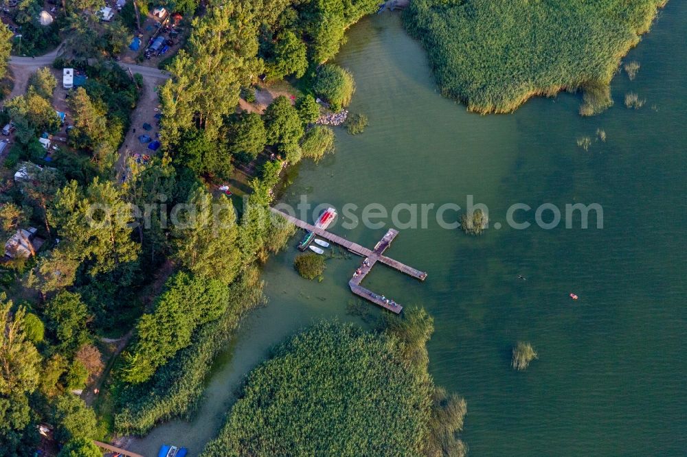 Oberuckersee from above - House boat berths and moorings on the shore area of Conping on Oberuckersee in the district Warnitz in Oberuckersee in the state Brandenburg, Germany