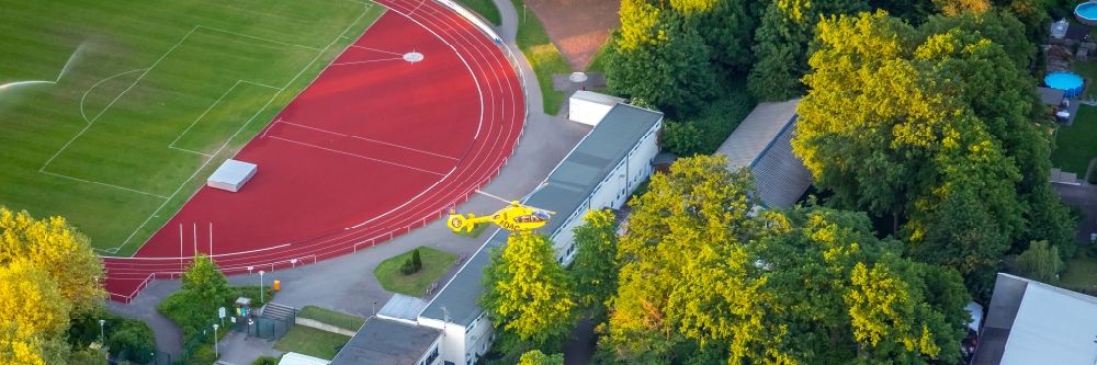 Bergkamen from the bird's eye view: Yellow Helicopter in flight company ADAC Luftrettung of type Eurocopter EC-135P-2 over the air space in Bergkamen in the state North Rhine-Westphalia, Germany