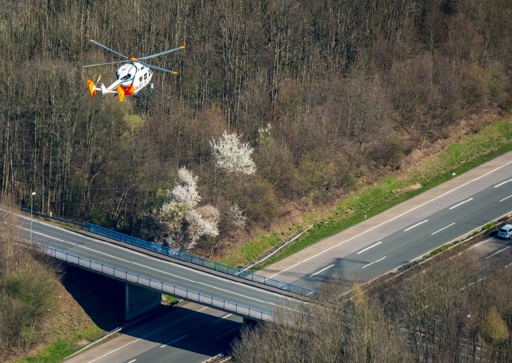 Aerial photograph Hagen - Helicopter in flight D-HNWO Eurocopter BK-117C1 in Police mission over the air space in the district Hohenlimburg in Hagen in the state North Rhine-Westphalia