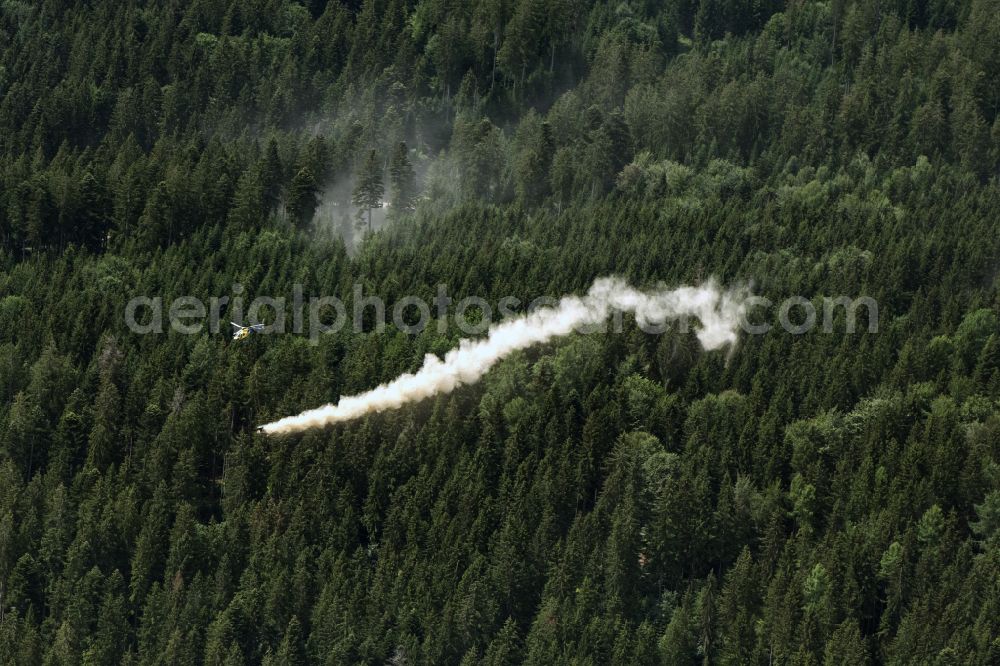 Cresbach from above - Helicopter - Helicopter operation in spray flight with a white dust plume for forest liming in flight over the airspace in Cresbach in the state Baden-Wuerttemberg, Germany