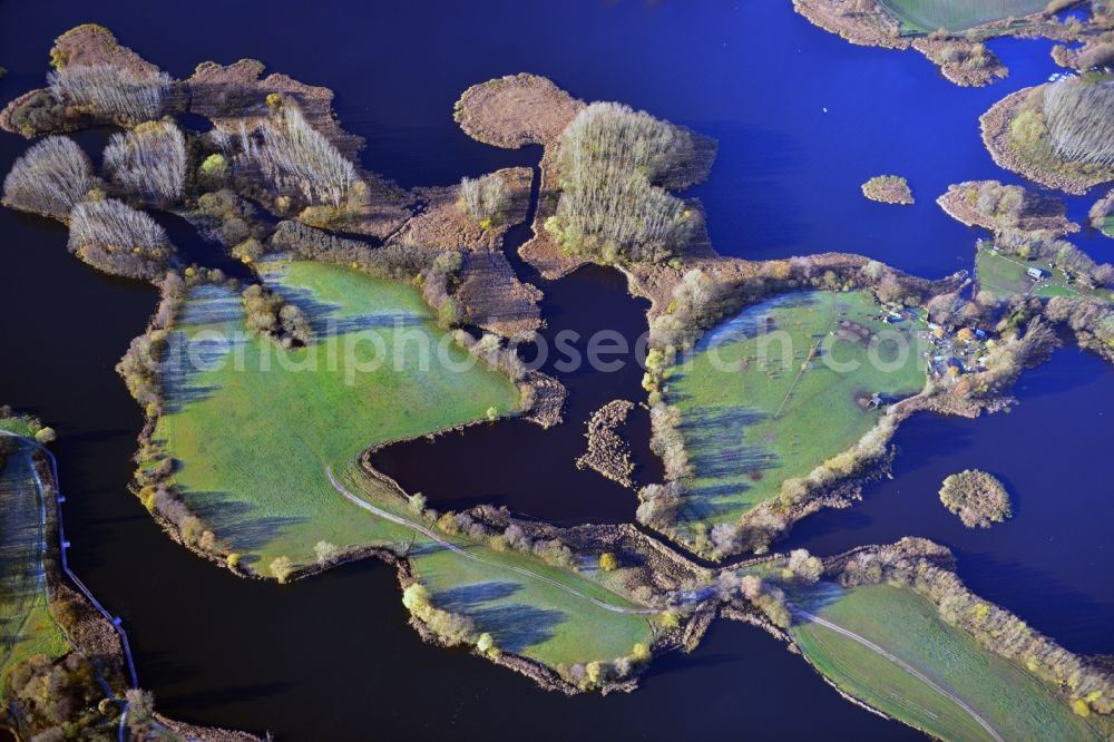 Aerial image Oberkrämer - View of the Mühlen lake in the local district Vehlefanz of the municipality Oberkrämer in Brandenburg. The lake was created by the LPG to be used as a water reservoir to irrigate the surrounding fields. To this day, the lake is still used for that