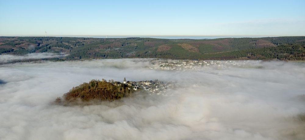 Meschede OT Bergstadt Eversberg from above - Autumn - Weather landscape over the space enclosed by clouds and haze district Eversberg in Meschede in the state of North Rhine-Westphalia