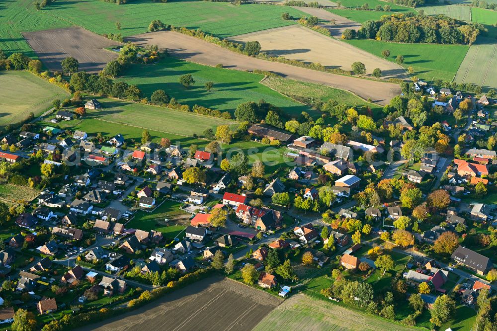Aerial photograph Kasseburg - Autumnal discolored vegetation view agricultural land and field boundaries surround the settlement area of the village in Kasseburg in the state Schleswig-Holstein, Germany