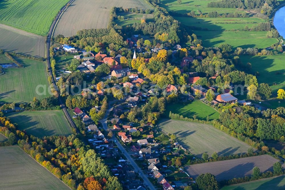 Siebeneichen from above - Autumnal discolored vegetation view agricultural land and field boundaries surround the settlement area of the village in Siebeneichen in the state Schleswig-Holstein, Germany