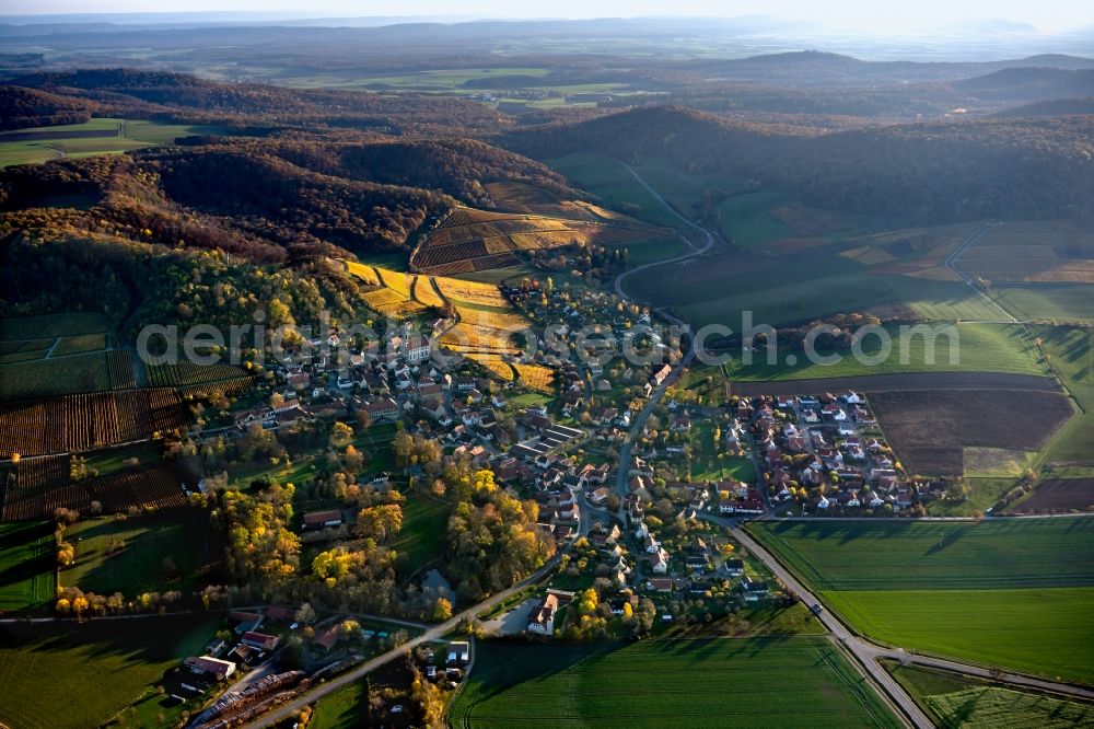 Castell from above - Autumnal discolored vegetation view village on the edge of vineyards and wineries in the wine-growing area in Castell in the state Bavaria, Germany