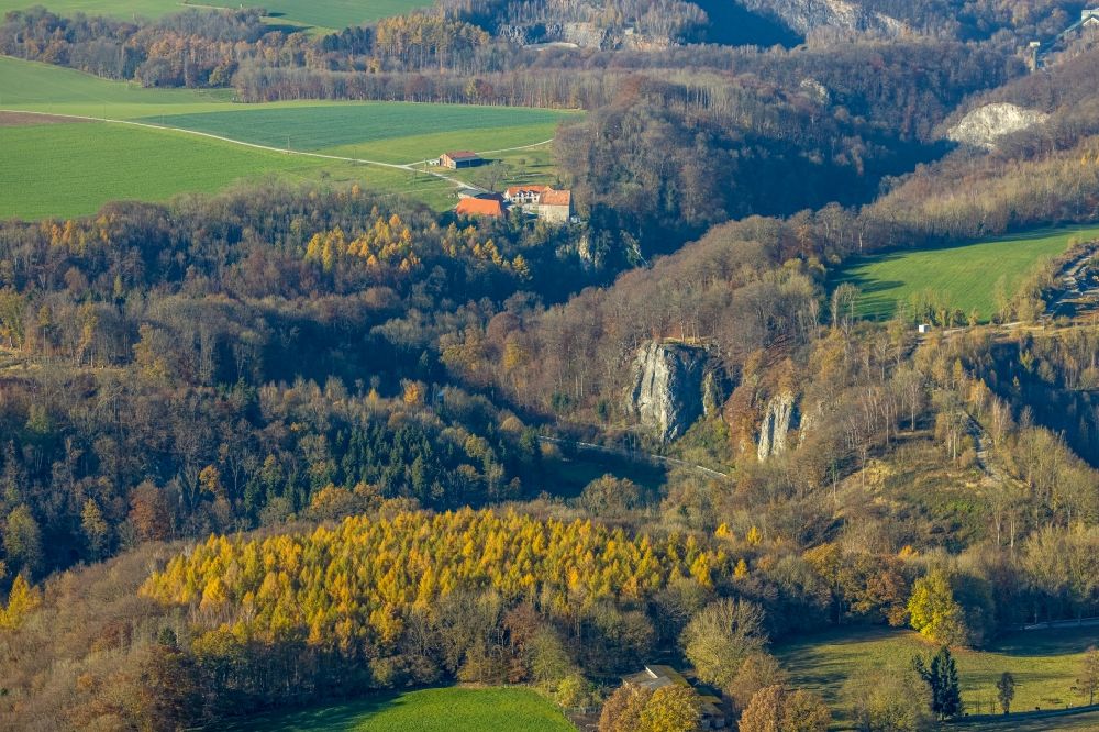 Aerial image Volkringhausen - Autumnal discolored vegetation view rock massif and rock formation Reckenhoehle - Tropfsteinhoehle in Volkringhausen in the state North Rhine-Westphalia, Germany