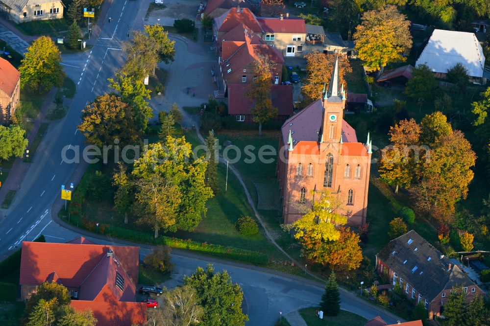 Aerial image Redefin - Autumnal discolored vegetation view church building on the school street in Redefin in the state Mecklenburg - Western Pomerania, Germany