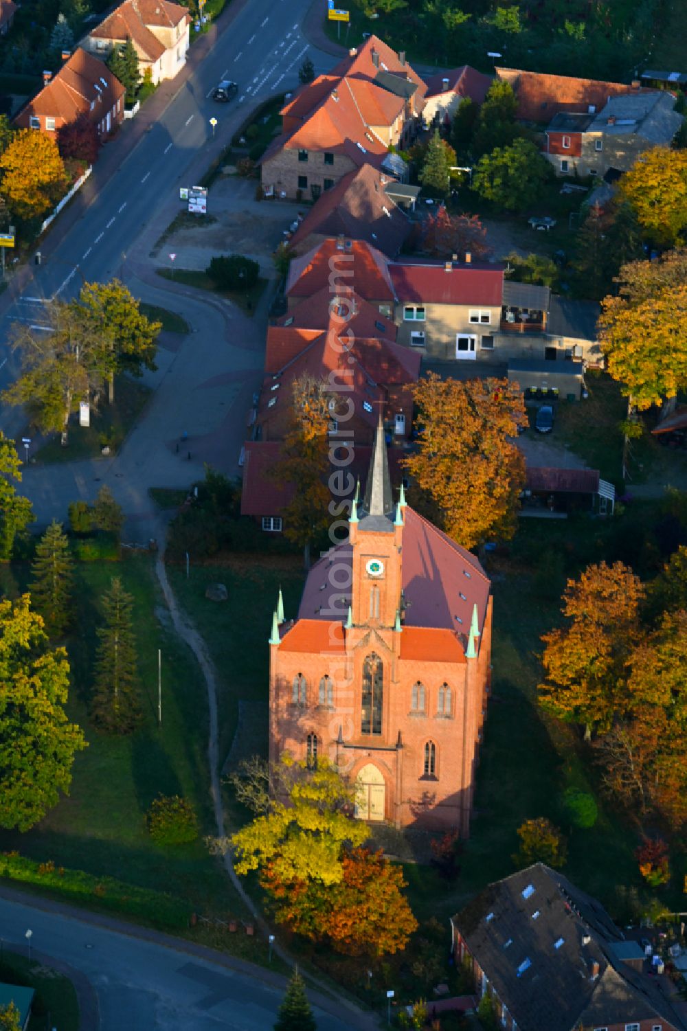 Aerial photograph Redefin - Autumnal discolored vegetation view church building on the school street in Redefin in the state Mecklenburg - Western Pomerania, Germany