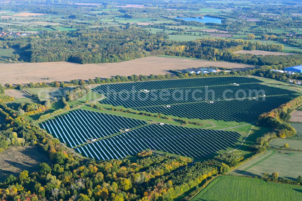 Lanken from the bird's eye view: Autumnal discolored vegetation view rows of panels of a solar power plant and photovoltaic system on a field in Lanken in the state Schleswig-Holstein, Germany