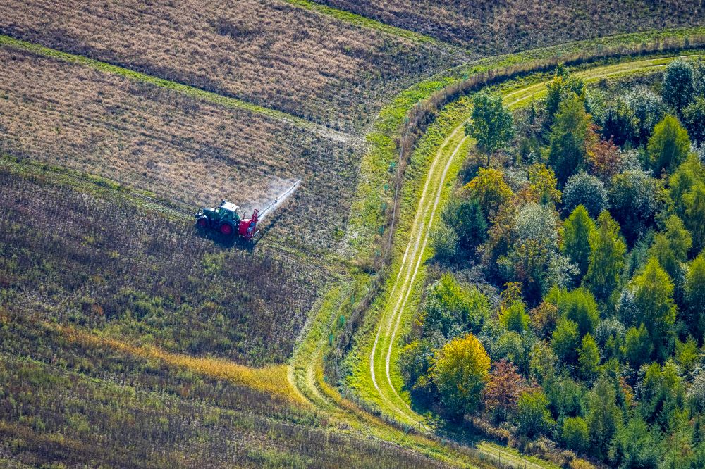 Aerial photograph Obringhausen - Autumnal discolored vegetation view transport vehicles in agricultural fields in Obringhausen in the state North Rhine-Westphalia, Germany