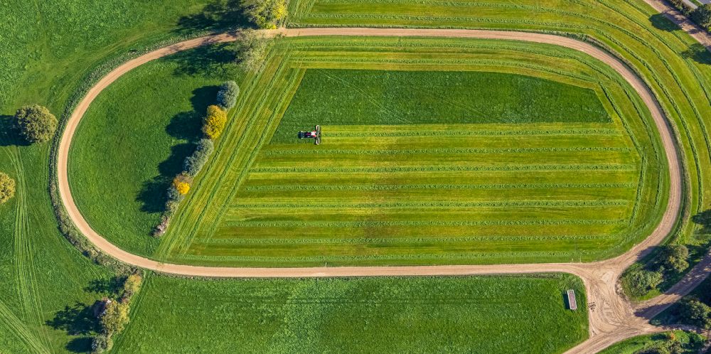 Aerial photograph Moers - Autumnal discolored vegetation view plowing and shifting the earth by a tractor with plow on agricultural fields in Moers in the state North Rhine-Westphalia, Germany