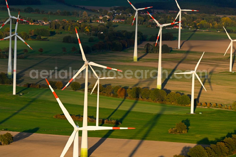 Aerial image Karwe - Autumnal discolored vegetation view wind turbines of a wind power plant on agricultural land and fields on the edge of the settlement area of the village in Karwe in the state Brandenburg, Germany